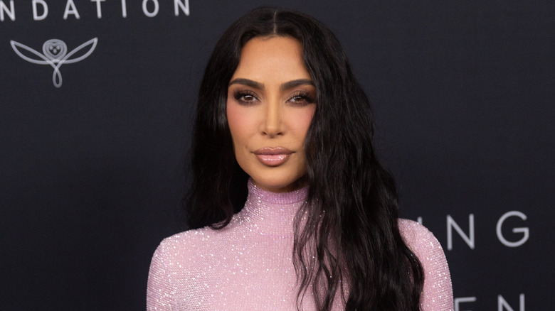 Closeup of Kim Kardashian posing on step-and-repeat