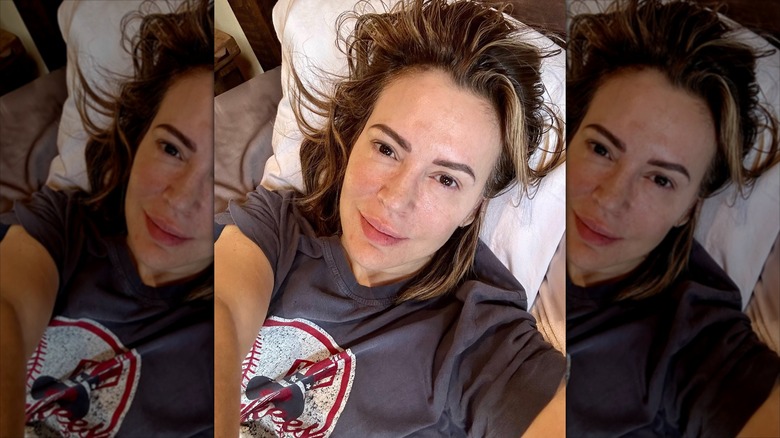 Alyssa Milano taking a selfie with no makeup wearing a T-shirt