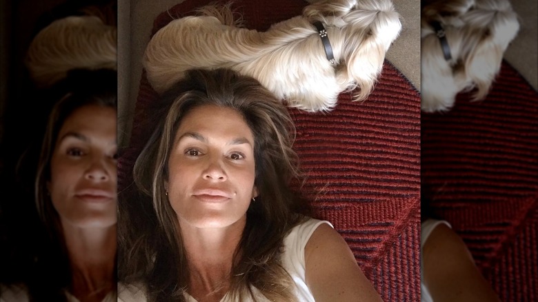 Cindy Crawford taking a selfie with a dog