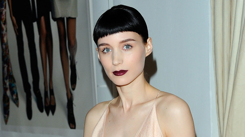 Rooney Mara wearing jet-black fringe and red lips