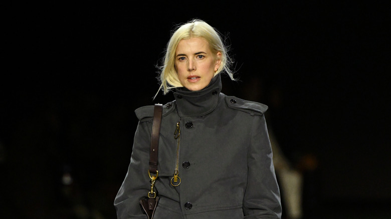 Agyness Deyn in a high-necked charcoal gray longcoat