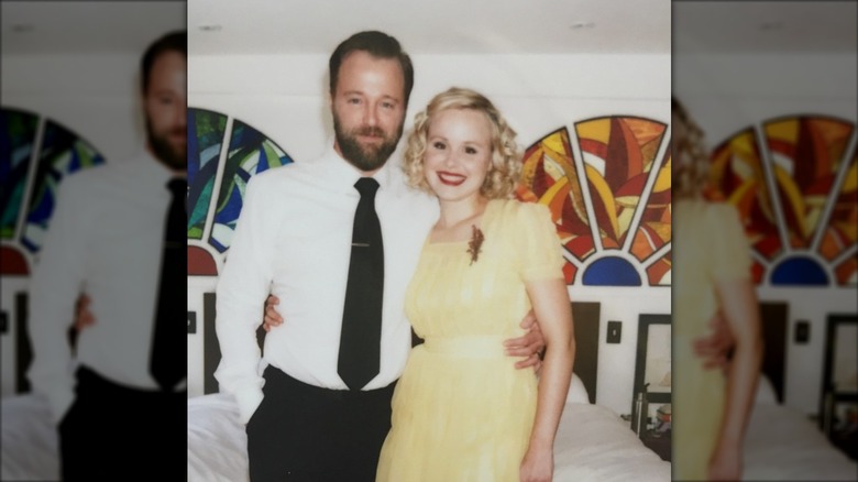 Alison Pill wearing a short golden bob and pink lipstick