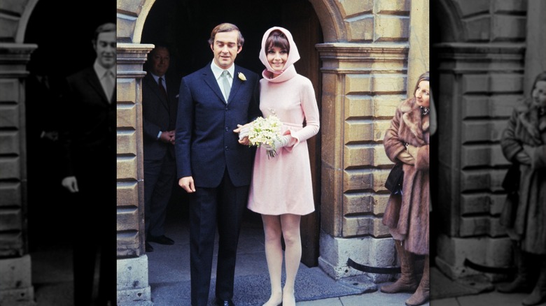 Audrey Hepburn in pink wedding dress beside Andrea Dotti