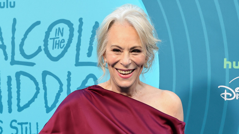 Jane Kaczmarek smiling in a one-shoulder red dress