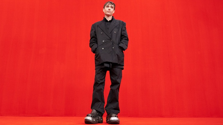 Elliot Page posing at the 2022 Balenciaga Womenswear Spring/Summer show