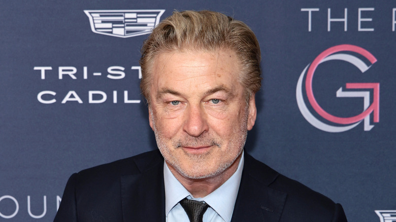 Alec Baldwin staring into the camera on the red carpet in March 2026