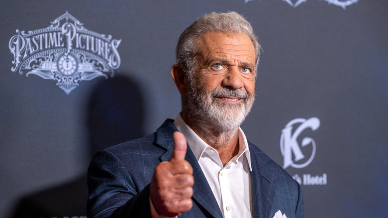 Mel Gibson giving a thumbs up on the red carpet in September 2024