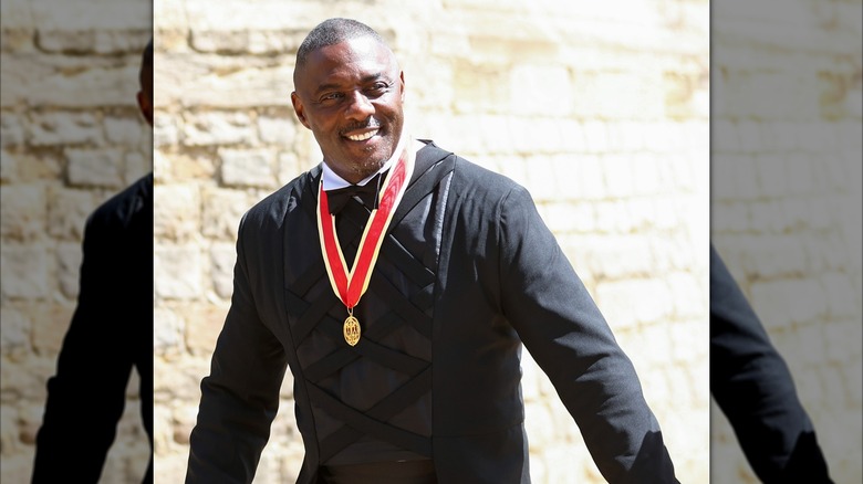 Idris Elba wearing his knighthood medal