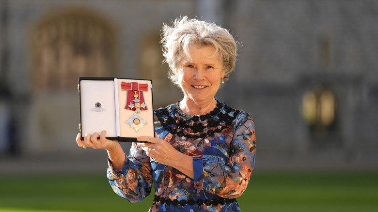 Imelda Staunton holding her damehood metal
