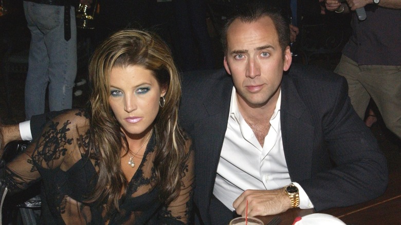Nicolas Cage and Lisa Marie Presley looking intense.
