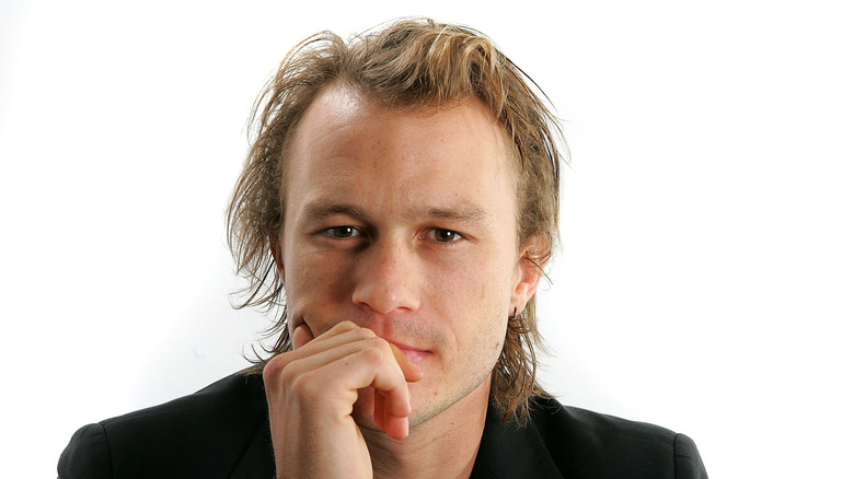 Heath Ledger posing against a white background