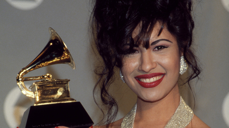 Selena Quintanilla smiling while holding her Grammy