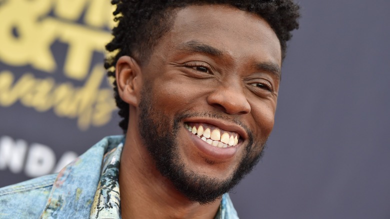Closeup of Chadwick Boseman grinning on step-and-repeat
