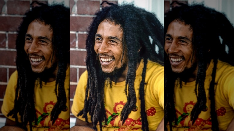 Bob Marley smiling in a yellow shirt