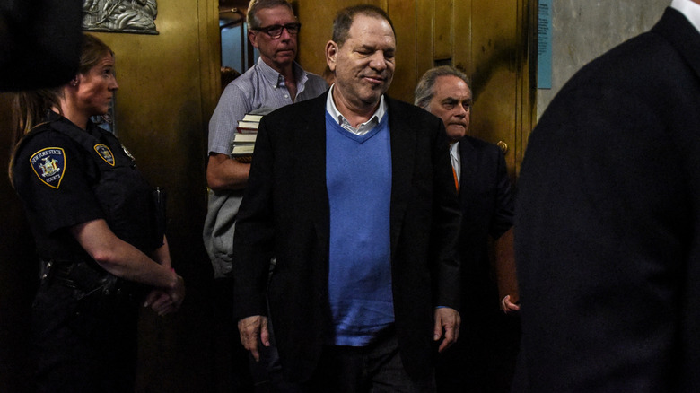 Harvey Weinstein surrounded by security guards and lawyers in court