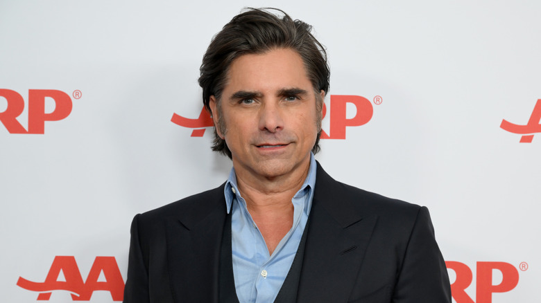 John Stamos posing for photos