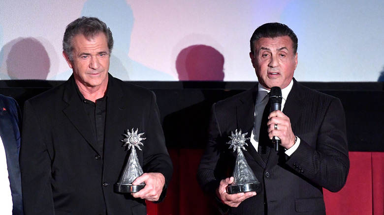 Sylvester Stallone and Mel Gibson accepting awards