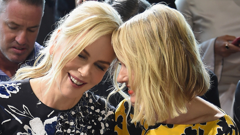 Nicole Kidman and Naomi Watts pressing heads togethr