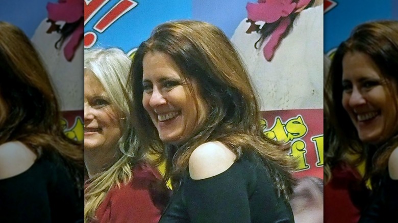 Felice Schachter smiling with a fan at an event in 2024