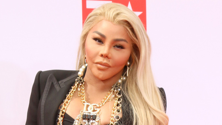 Lil' Kim posing on step-and-repeat