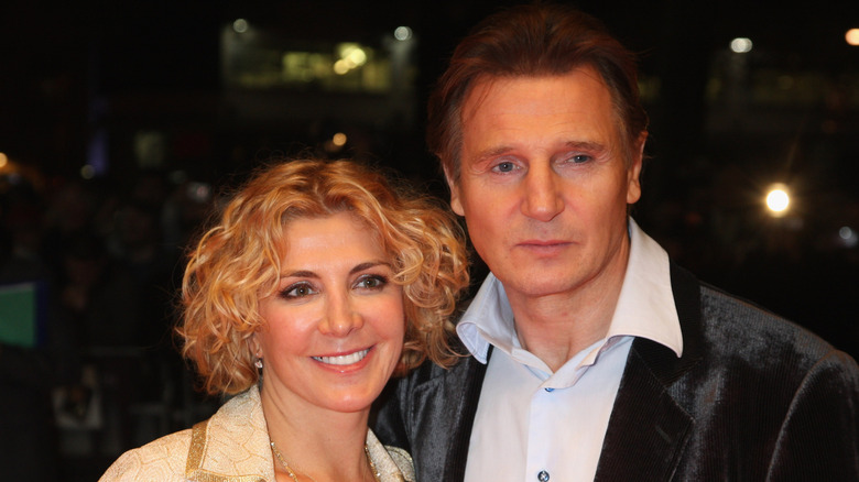 Natasha Richardson with short curly hair beside Liam Neeson