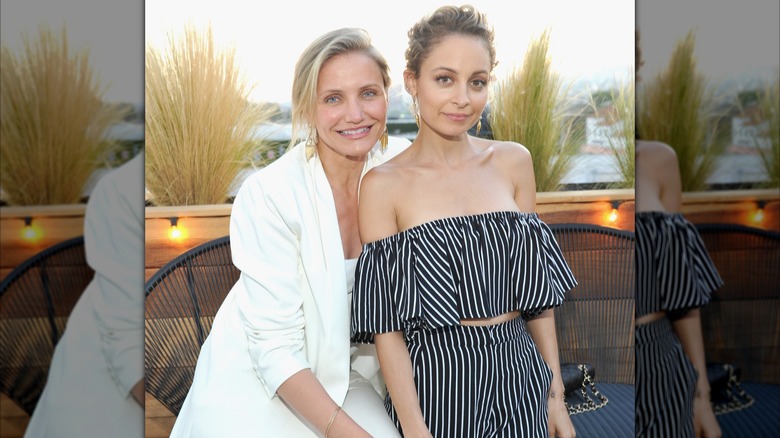 Cameron Diaz and Nicole Richie smiling and hanging out together.