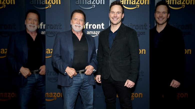 Arnold Schwarzenegger and Chris Pratt smiling at an Amazon Upfront event.