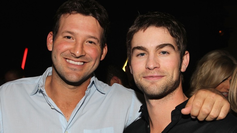 Tony Romo smiling with his arm around Chace Crawford.