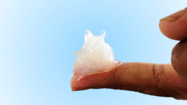 Thick ointment on extended finger