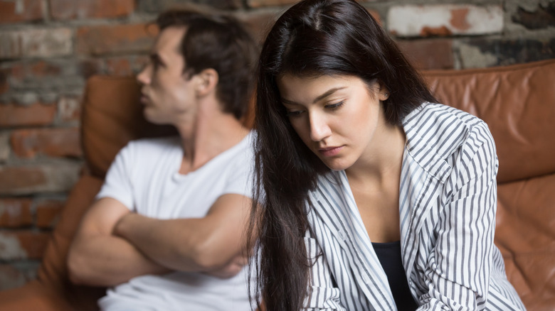 stressed couple on couch