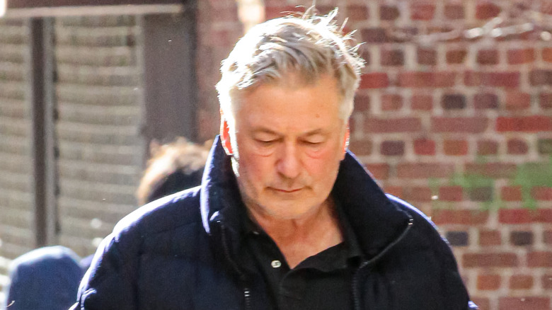 Alec Baldwin wearing a black coat