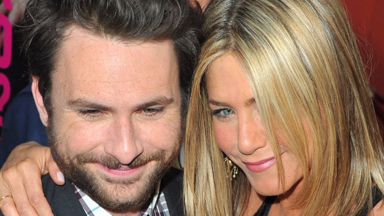 Charlie Day and Jennifer Aniston embracing 