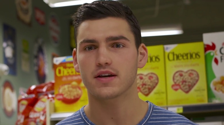 Charlie Hall playing himself in a supermarket cereal aisle in his web series Sorry Charlie.