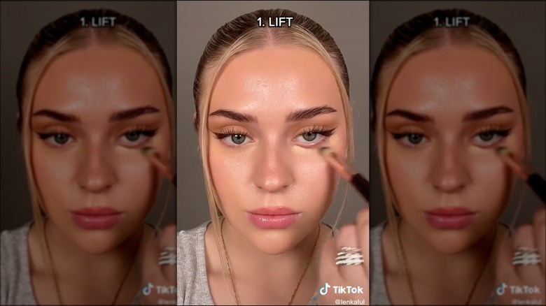 Woman applying concealer