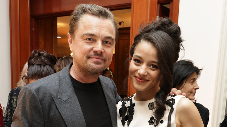 Leonardo DiCaprio and Chase Infiniti smiling while posing together