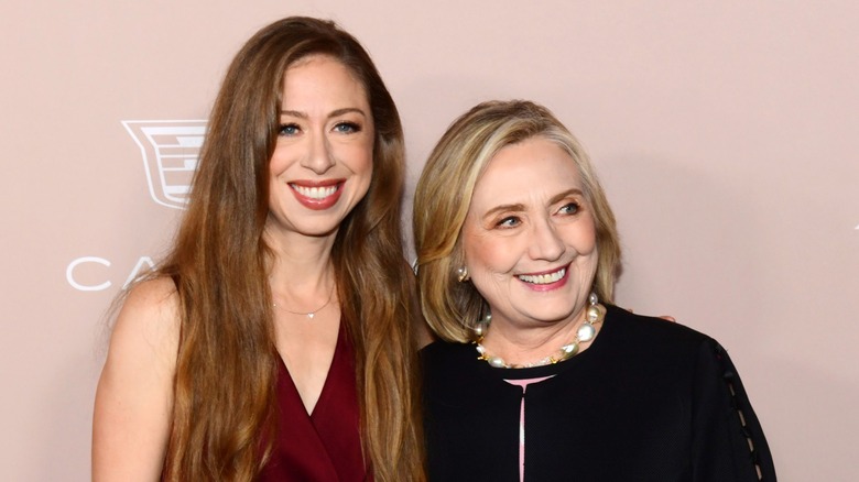 Chelson Clinton smiling with Hillary at event