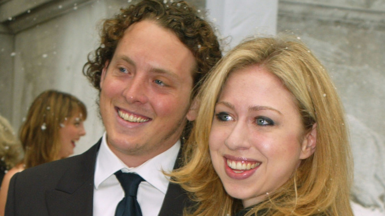 Ian Klaus and Chelsea Clinton smiling together in the snow.
