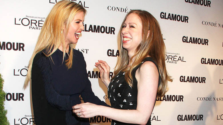 Ivanka Trump and Chelsea Clinton laughing together on a red carpet