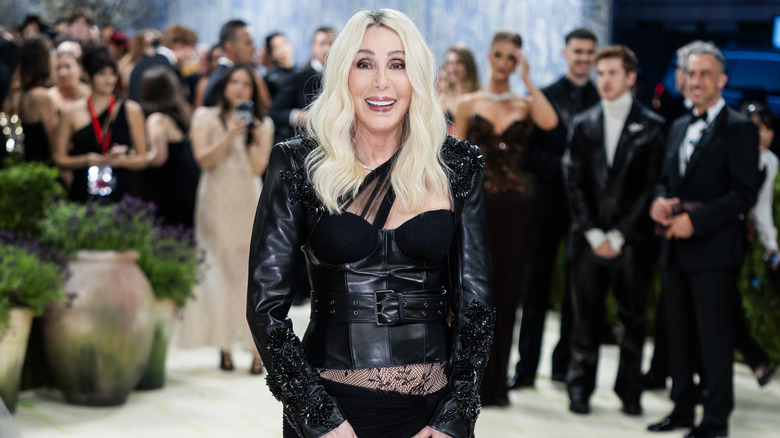 Cher in a black corset with black leather jacket