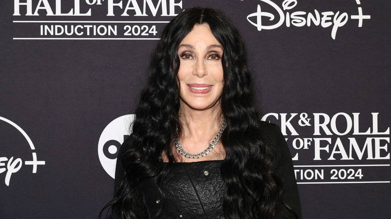 Cher in a black dress and silver necklace