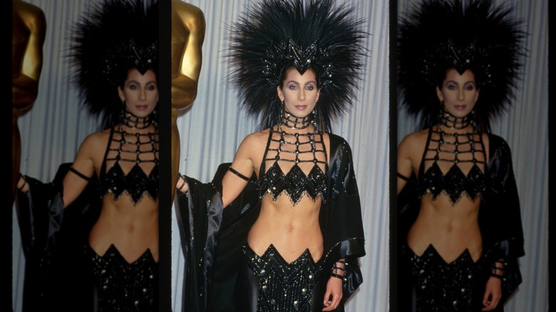Cher wore a sparkly black outfit and huge headress