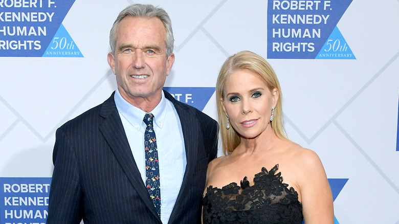 Cheryl Hines and RFK Jr. posing at an event together