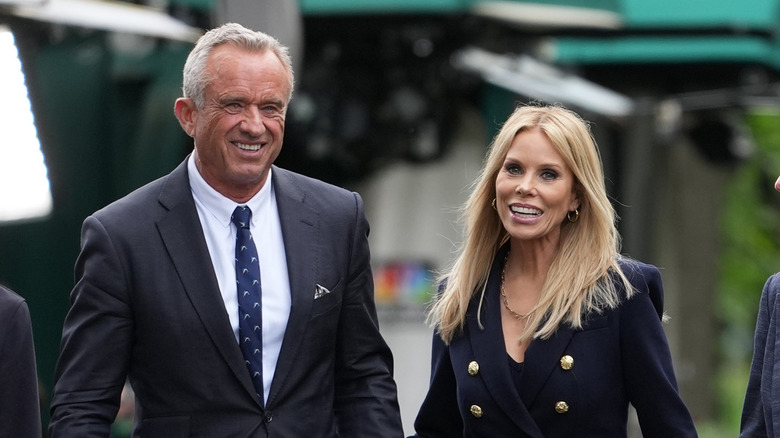RFK Jr. and Cheryl Hines smiling and walking together