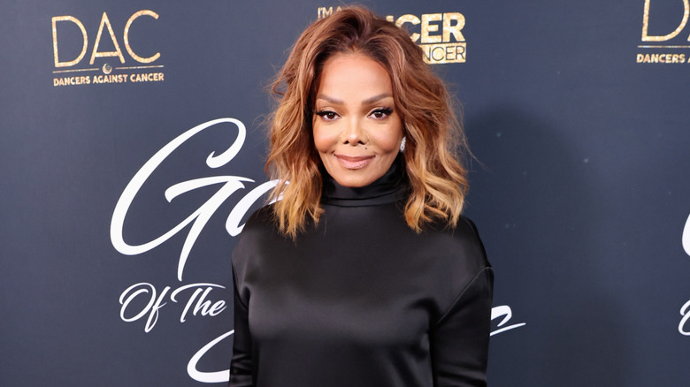 Janet Jackson smiling at a charity gala.