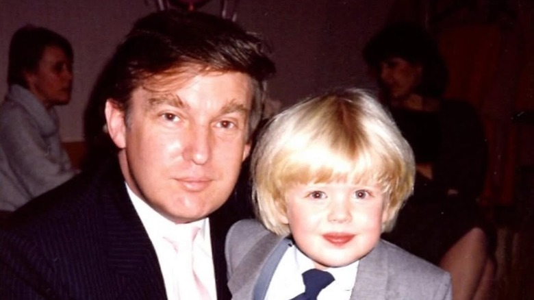 A young Donald Trump pose with toddler son Eric Trump