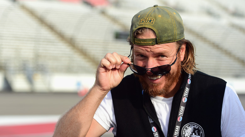 Chip Gaines lowers his sunglasses with a smile