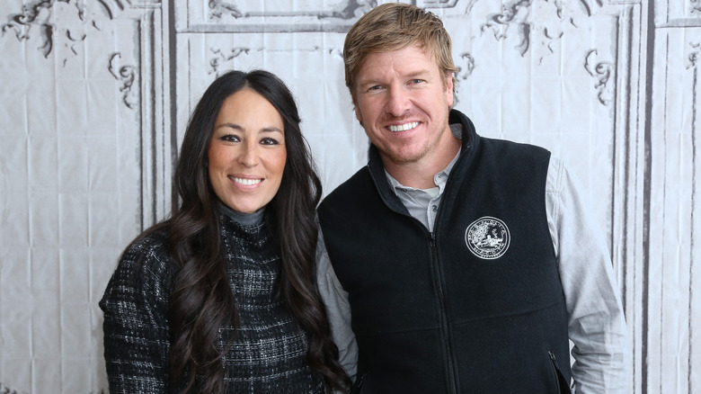 Chip Gaines smiling with Chip Gaines leaning into her with a grin.