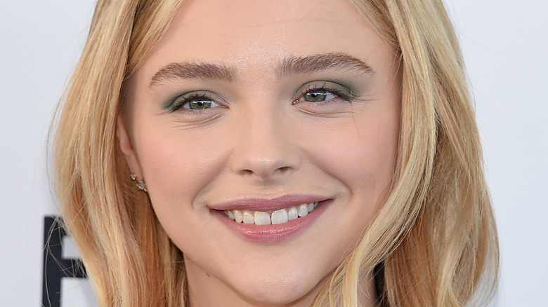 Chloe Grace Moretz smiling for press