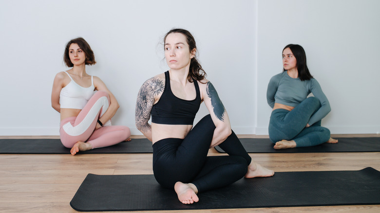 three women doing yoga