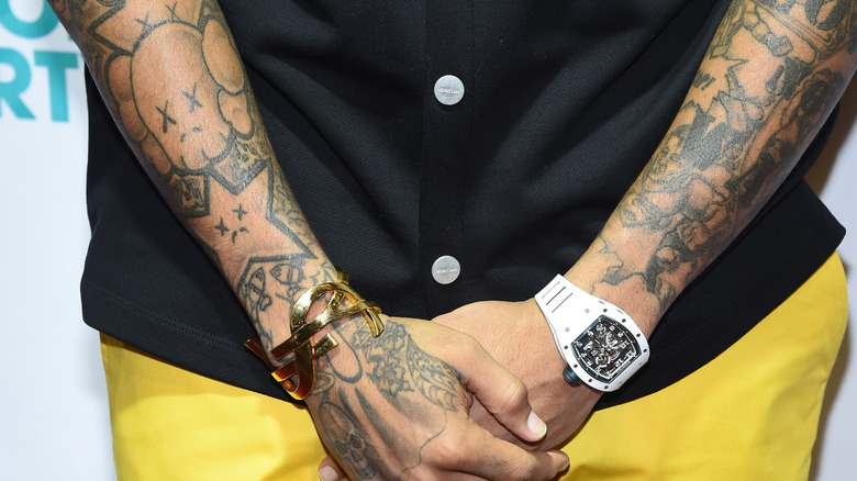 Chris Brown shows off his arm tattoos
